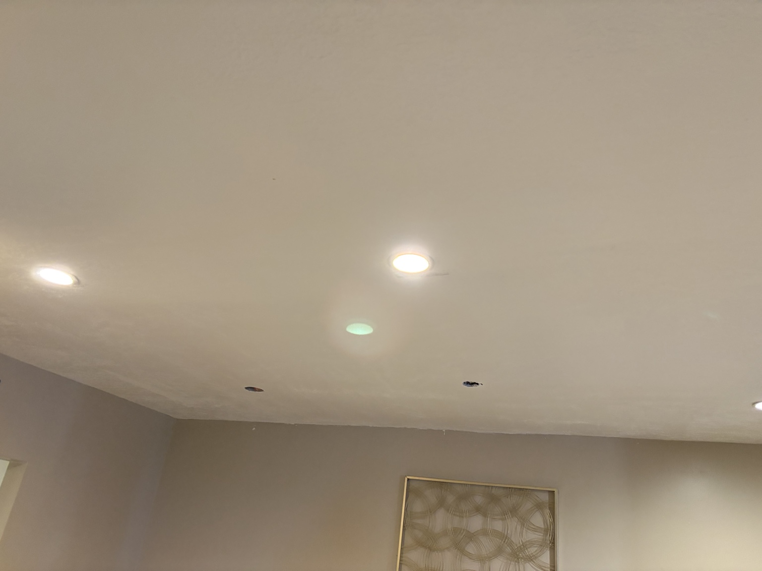 Finished ceiling with smooth surface and recessed lighting
