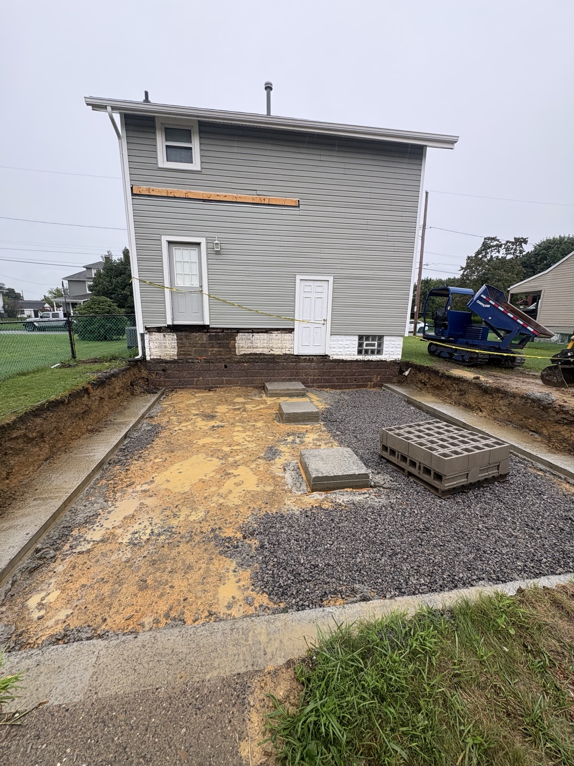 Excavated and prepared foundation area for a house addition